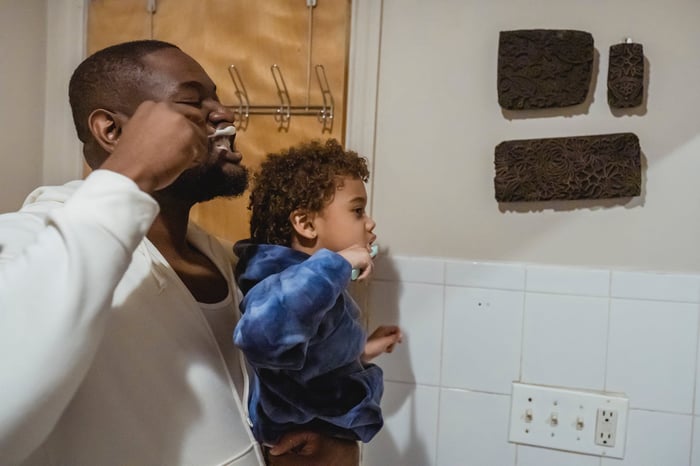 A father and a son brushing their teeth